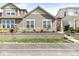 A well-maintained home with a stone retaining wall, landscaping, and a patriotic American flag at 7092 Cherry Creek Blvd, Carmel, IN 46033