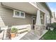 Covered front porch with a bench, potted plants, and brick-based pillars at 7092 Cherry Creek Blvd, Carmel, IN 46033