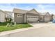 Home with attached two-car garage and front yard with sidewalk and small sitting area at 7092 Cherry Creek Blvd, Carmel, IN 46033