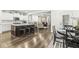 Open-concept kitchen and living area with a large island and hardwood floors at 7092 Cherry Creek Blvd, Carmel, IN 46033