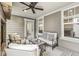 Relaxing covered outdoor patio featuring plush seating, a ceiling fan, and a cozy fireplace at 7092 Cherry Creek Blvd, Carmel, IN 46033