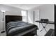 Cozy bedroom featuring a dark bed frame, soft carpeting, and a keyboard set up for musical enjoyment at 7195 E Rising Sun S Cir, Camby, IN 46113