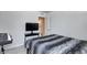 Neutral bedroom showcasing a well-made bed, TV, and sleek black keyboard for entertainment at 7195 E Rising Sun S Cir, Camby, IN 46113