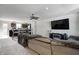 Inviting living room open to the kitchen with a comfortable sectional sofa and entertainment center at 7195 E Rising Sun S Cir, Camby, IN 46113