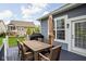 Back deck featuring a wooden dining table, chairs, and umbrella at 7450 Cassilly Ct, Indianapolis, IN 46278