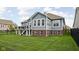 Exterior shot of a two-story home, showing a deck and a spacious, well-manicured lawn at 7450 Cassilly Ct, Indianapolis, IN 46278