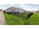 Spacious backyard features a black fence, deck, and lush green lawn at 7450 Cassilly Ct, Indianapolis, IN 46278