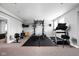 Basement workout area features weightlifting rack, treadmill, rowing machine, and rubber flooring at 7450 Cassilly Ct, Indianapolis, IN 46278