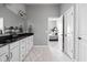Bright bathroom with double sinks, white cabinetry and walk through to bedroom at 7450 Cassilly Ct, Indianapolis, IN 46278