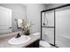 Neutral bathroom featuring a glass-enclosed shower, sink, and vanity at 7450 Cassilly Ct, Indianapolis, IN 46278