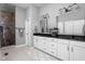 Bright bathroom featuring dual vanities, white cabinetry, and a separate tiled shower area at 7450 Cassilly Ct, Indianapolis, IN 46278