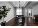 Elegant dining area with a tray ceiling, chandelier, and access to the kitchen and living spaces at 7450 Cassilly Ct, Indianapolis, IN 46278
