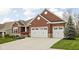 Beautiful red brick home with a well-kept lawn and a convenient two-car garage at 7450 Cassilly Ct, Indianapolis, IN 46278
