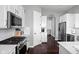 Modern kitchen featuring white cabinets, granite countertops, and stainless-steel appliances for cooking ease at 7450 Cassilly Ct, Indianapolis, IN 46278