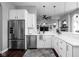 Bright kitchen with stainless steel appliances, white cabinetry, and a seamless connection to living spaces at 7450 Cassilly Ct, Indianapolis, IN 46278