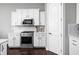 Contemporary kitchen boasting white cabinets, stainless steel appliances, and sleek countertops for the home chef at 7450 Cassilly Ct, Indianapolis, IN 46278
