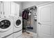 Laundry room with washer, dryer, cabinets, and hanging rack at 7450 Cassilly Ct, Indianapolis, IN 46278