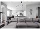 Open-concept living area featuring a large sectional sofa and views into the kitchen and dining room at 7450 Cassilly Ct, Indianapolis, IN 46278