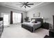 Large main bedroom with a ceiling fan, a king bed, a door to a balcony, and two nightstands at 7450 Cassilly Ct, Indianapolis, IN 46278