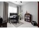 Functional office space featuring a desk, dual monitors, a bookshelf, and soft natural light at 7450 Cassilly Ct, Indianapolis, IN 46278