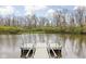 Scenic view of a pond with a dock, surrounded by lush greenery at 7450 Cassilly Ct, Indianapolis, IN 46278