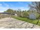 A beautiful backyard features a gazebo, shed, green lawn, and many trees at 7841 Whitaker Farms Ln, Indianapolis, IN 46237