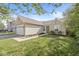 Inviting single-Gathering home with a two-car garage, partial brick facade, and a neatly kept lawn at 7841 Whitaker Farms Ln, Indianapolis, IN 46237