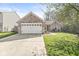 A well-maintained brick home featuring an attached garage, a welcoming entrance, and a lush green lawn at 7841 Whitaker Farms Ln, Indianapolis, IN 46237