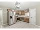Updated kitchen featuring stainless steel appliances, wood cabinets, and tile flooring at 7841 Whitaker Farms Ln, Indianapolis, IN 46237