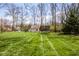 Expansive backyard featuring a large grassy area, shed, and trampoline at 7845 Allisonville Rd, Indianapolis, IN 46250