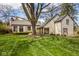 Lush green backyard with mature trees, offering a serene outdoor space at 7845 Allisonville Rd, Indianapolis, IN 46250