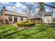 Lush backyard with manicured hedges, a dining area, and mature trees at 7845 Allisonville Rd, Indianapolis, IN 46250