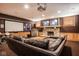 Entertainment basement with stone fireplace, sports memorabilia, wet bar, movie screen, and comfortable seating at 7845 Allisonville Rd, Indianapolis, IN 46250