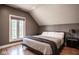 Bedroom with vaulted ceiling, hardwood flooring, and large window at 7845 Allisonville Rd, Indianapolis, IN 46250