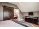 Bedroom featuring a sliding barn door, hardwood floors, and sleek, contemporary furniture at 7845 Allisonville Rd, Indianapolis, IN 46250