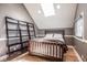 Charming bedroom featuring a skylight, hardwood floors, and custom shelving at 7845 Allisonville Rd, Indianapolis, IN 46250