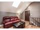 Bonus room with skylights, seating, and stained wood barn door at 7845 Allisonville Rd, Indianapolis, IN 46250