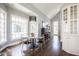 Bright breakfast nook with ample windows, modern chandelier, and piano in the background at 7845 Allisonville Rd, Indianapolis, IN 46250