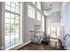 An inviting foyer showcasing soaring ceilings, large windows, and an elegant staircase at 7845 Allisonville Rd, Indianapolis, IN 46250