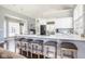 Gourmet kitchen featuring a large island with seating, stainless steel appliances, and a view of the breakfast nook at 7845 Allisonville Rd, Indianapolis, IN 46250