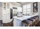 Bright kitchen featuring white cabinets, stainless steel appliances, and a large island with barstool seating at 7845 Allisonville Rd, Indianapolis, IN 46250
