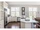 Spacious kitchen with stainless steel appliances, white countertops, and access to a sunlit patio at 7845 Allisonville Rd, Indianapolis, IN 46250