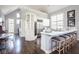 Open kitchen with white cabinets, stainless appliances, and large island with seating at 7845 Allisonville Rd, Indianapolis, IN 46250