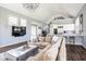Open-concept living space with modern furnishings and a glimpse into the gourmet kitchen at 7845 Allisonville Rd, Indianapolis, IN 46250