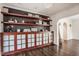 Stylish living room with custom built-in shelving, modern lighting, and beautiful dark wood flooring at 7845 Allisonville Rd, Indianapolis, IN 46250