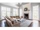 Spacious living room with a large sectional, fireplace, and plenty of natural light at 7845 Allisonville Rd, Indianapolis, IN 46250