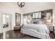 The large bedroom features hardwood floors, a large bed, and lots of natural light through the windows at 7845 Allisonville Rd, Indianapolis, IN 46250