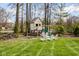 Backyard playhouse with swing set, fire pit, and Adirondack chairs at 7845 Allisonville Rd, Indianapolis, IN 46250