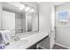 Stylish bathroom featuring a vanity with a modern sink, large mirror, and a shower-tub combination at 7901 Apalachee Dr, Indianapolis, IN 46217
