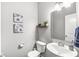Charming powder room with elegant fixtures, stylish mirror, and tasteful decorations at 7901 Apalachee Dr, Indianapolis, IN 46217